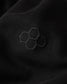 Close-up of a black fabric with an embroidered hexagonal pattern.