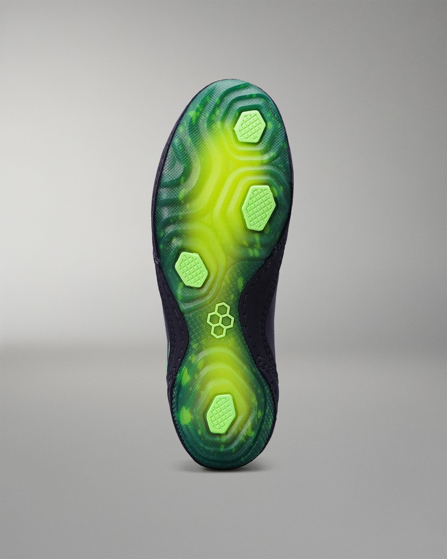 Green and black Wrestling shoe sole on a gray background