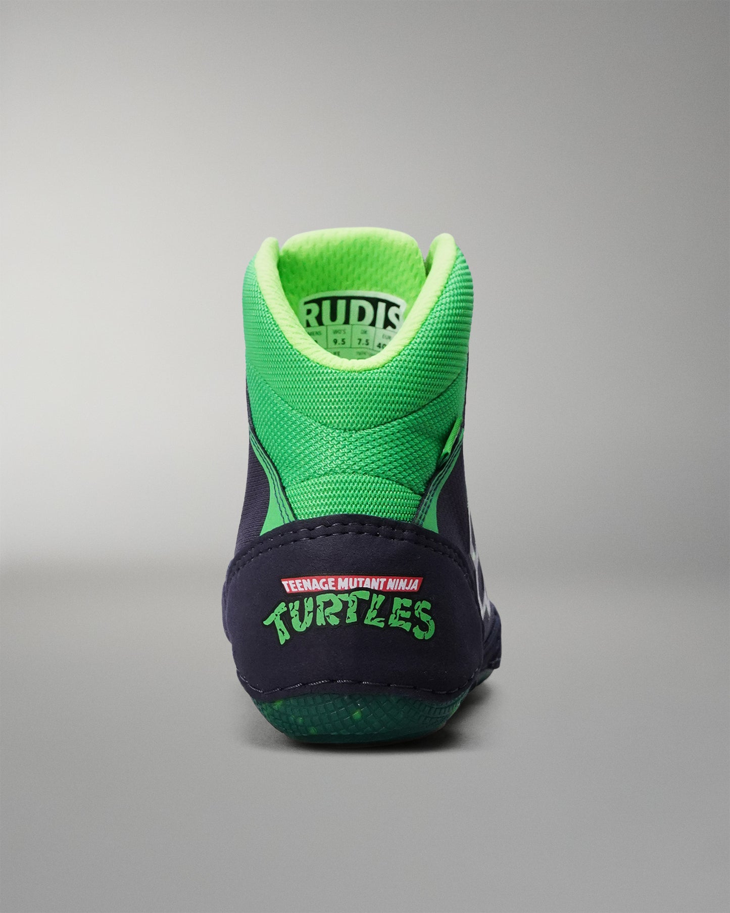 Green and navy Wrestling shoe with 'Rudis' branding on a gray background