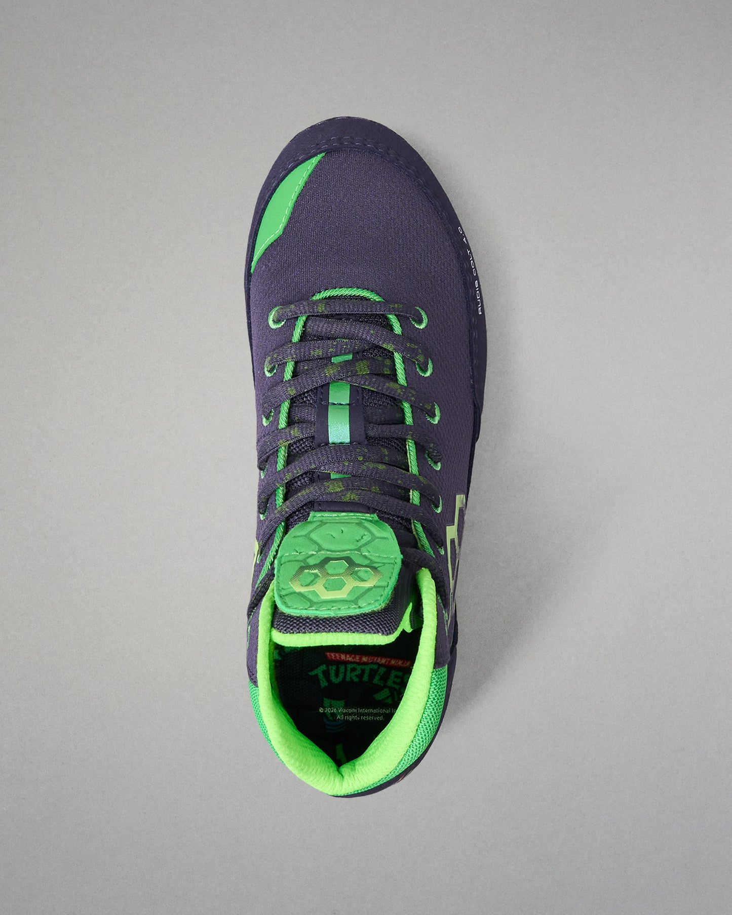 Navy and green Wrestling shoe on a gray background