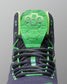 Close-up of a Wrestling shoe with green and black design on a gray background