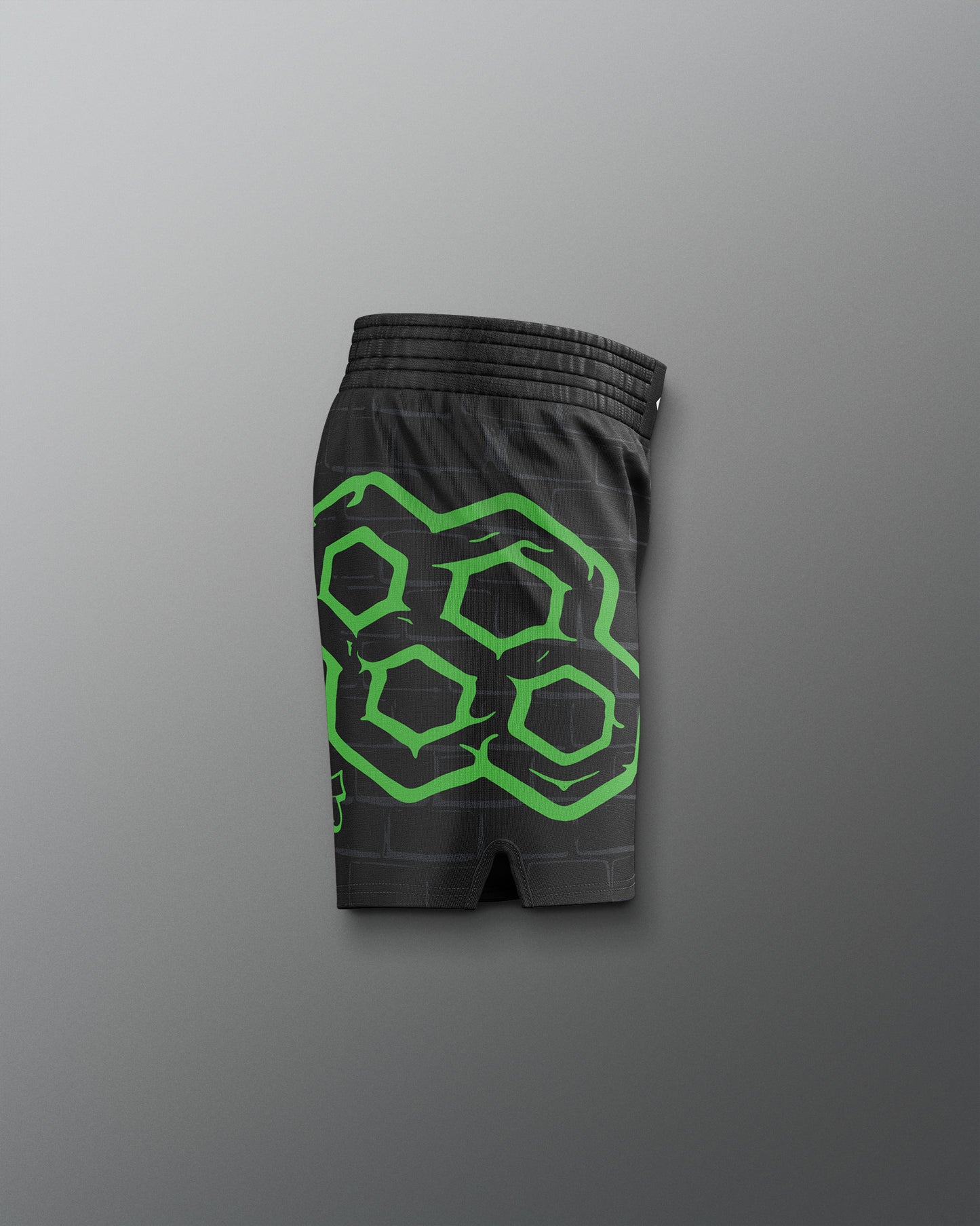 Black shorts with green geometric pattern on a gray background. TMNT. Teenage Mutant Ninja Turtle
