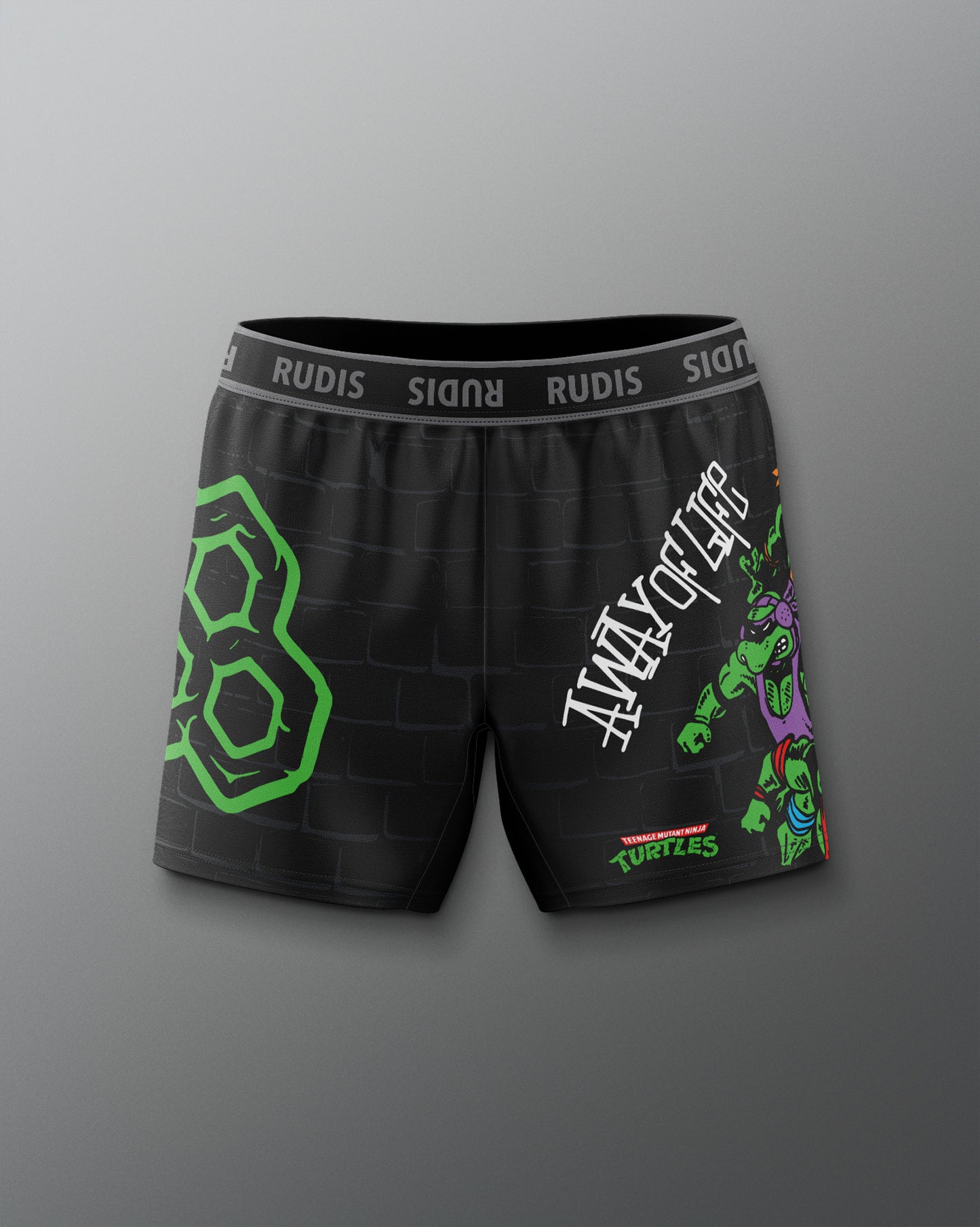 Black shorts with green and white designs on a gray background. TMNT. Teenage Mutant Ninja Turtle