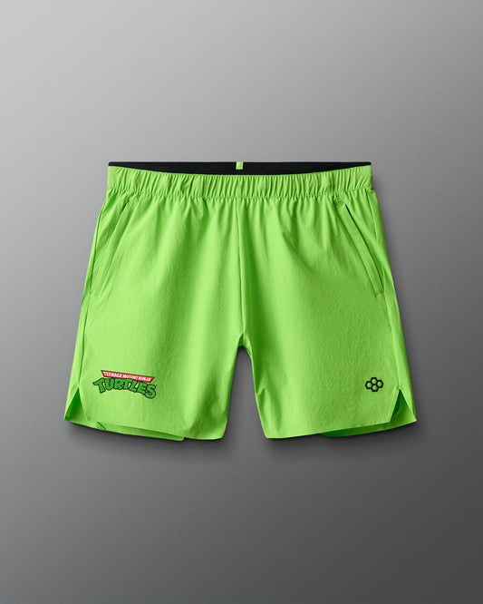 Neon green shorts with 'Teenage Mutant Ninja Turtles' logos on a gray background