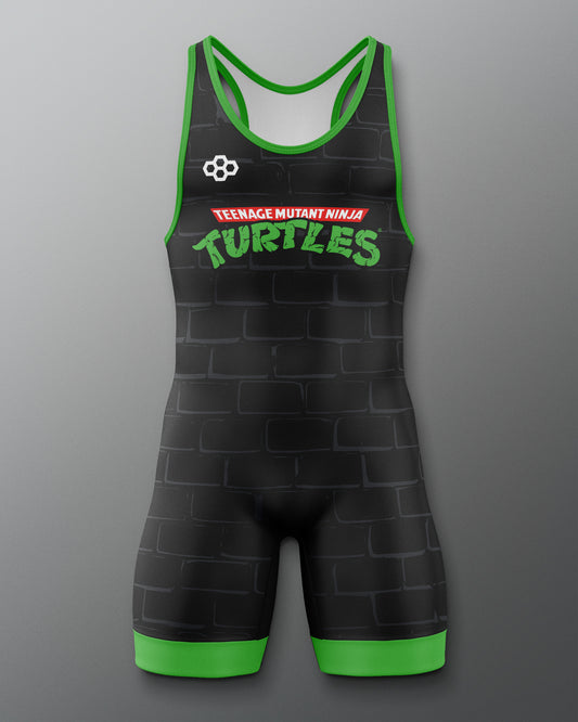 Black wrestling singlet with green accents featuring 'Teenage Mutant Ninja Turtles' text on a gray background