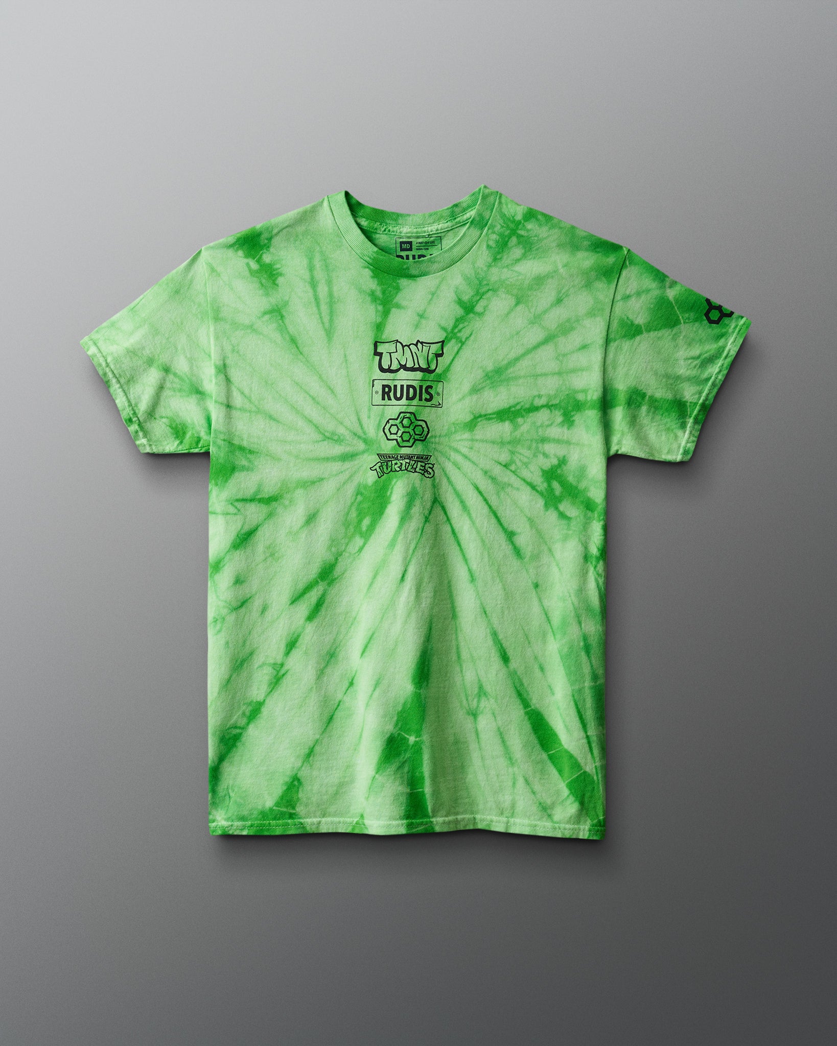 Green tie-dye t-shirt with branding on a gray background. TMNT. Teenage Mutant Ninja Turtles