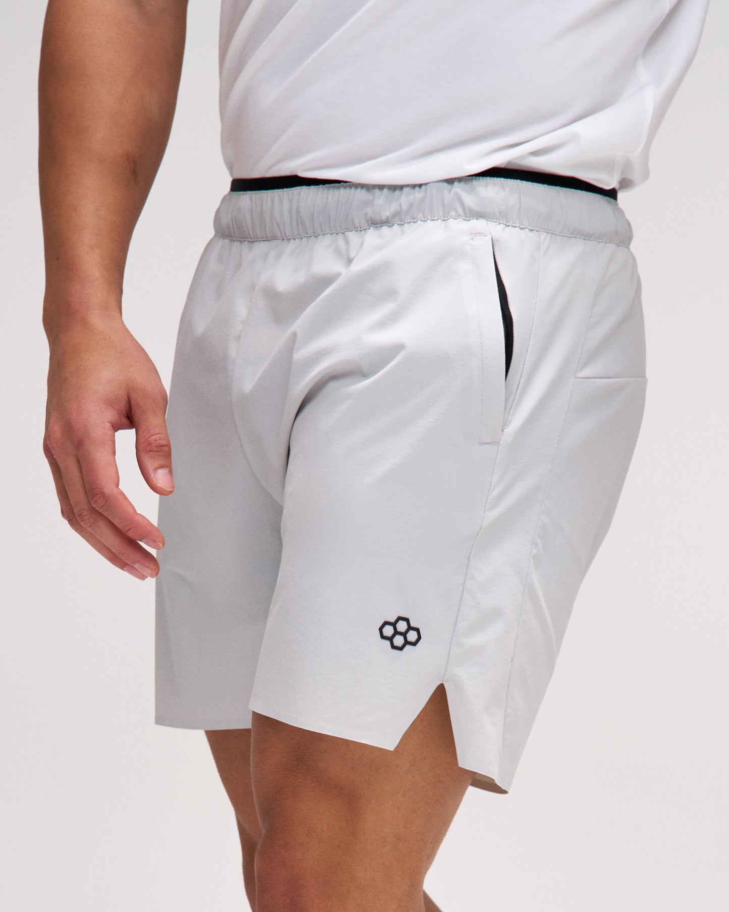 White athletic shorts with a small logo on a plain background