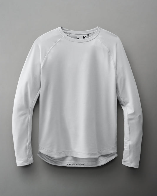 Light gray long-sleeve athletic shirt with a textured fabric and the phrase 'MIND BODY HEART SOUL' at the hem, set against a soft gray backdrop.
