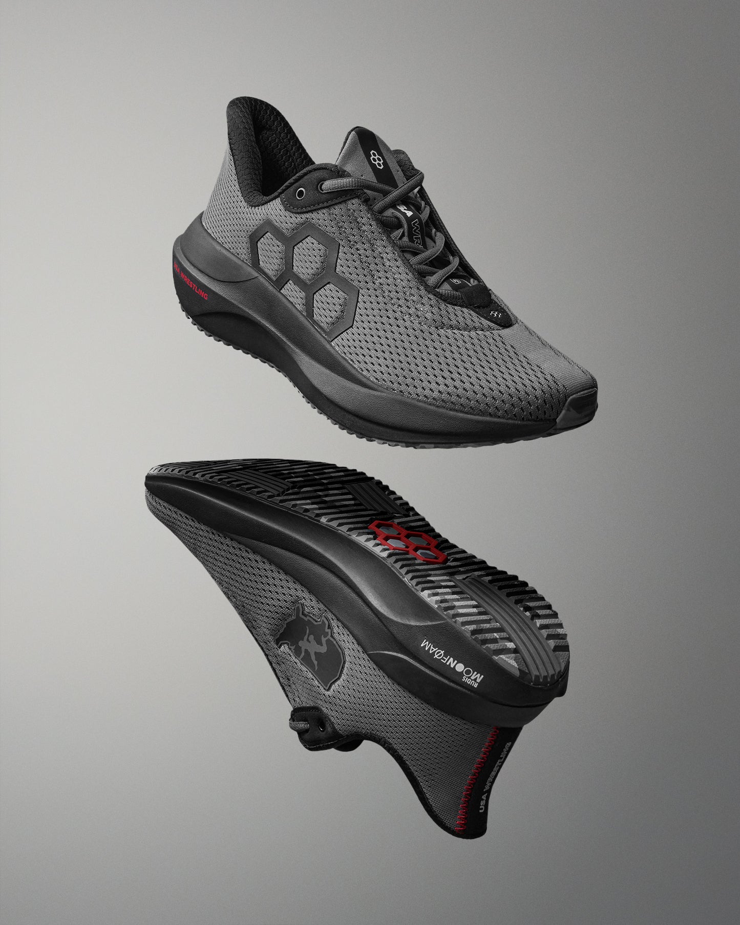 Gray athletic shoe with black sole on a gray background