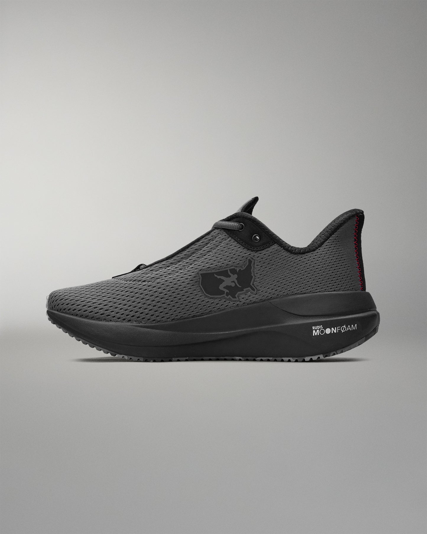 gray running shoe with black sole on a white background