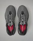 Gray athletic shoes with red lining on a gray background