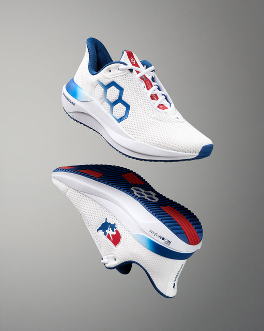 White running shoe with blue and red accents on a gray background