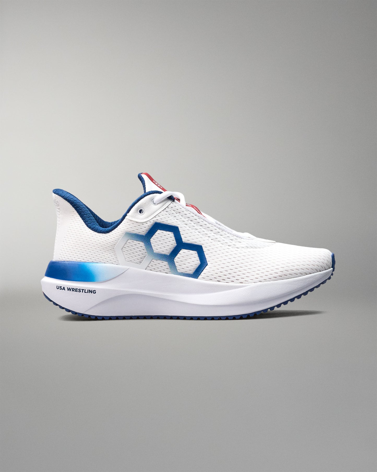 White athletic shoe with blue accents on a gray background