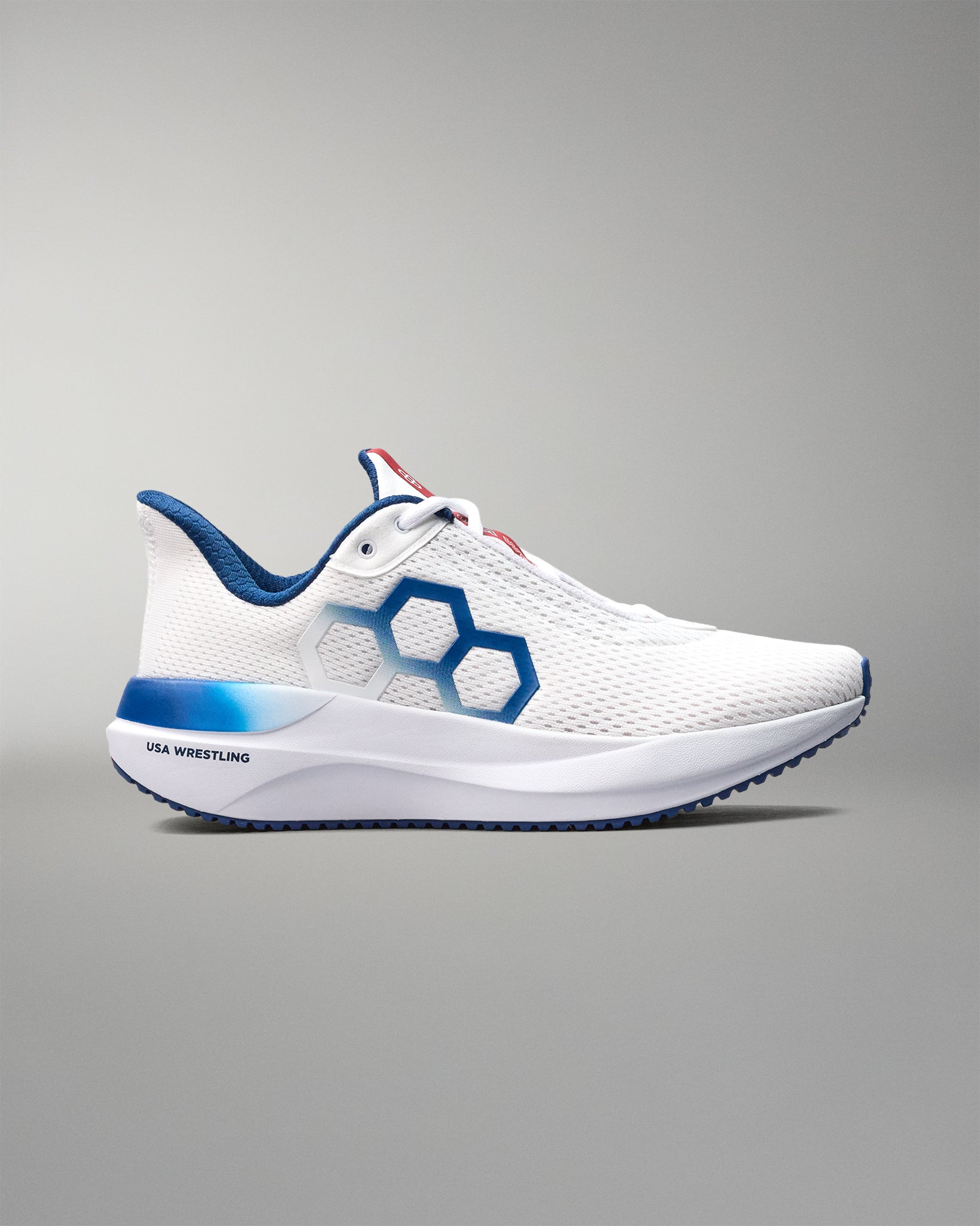 White athletic shoe with blue accents on a gray background