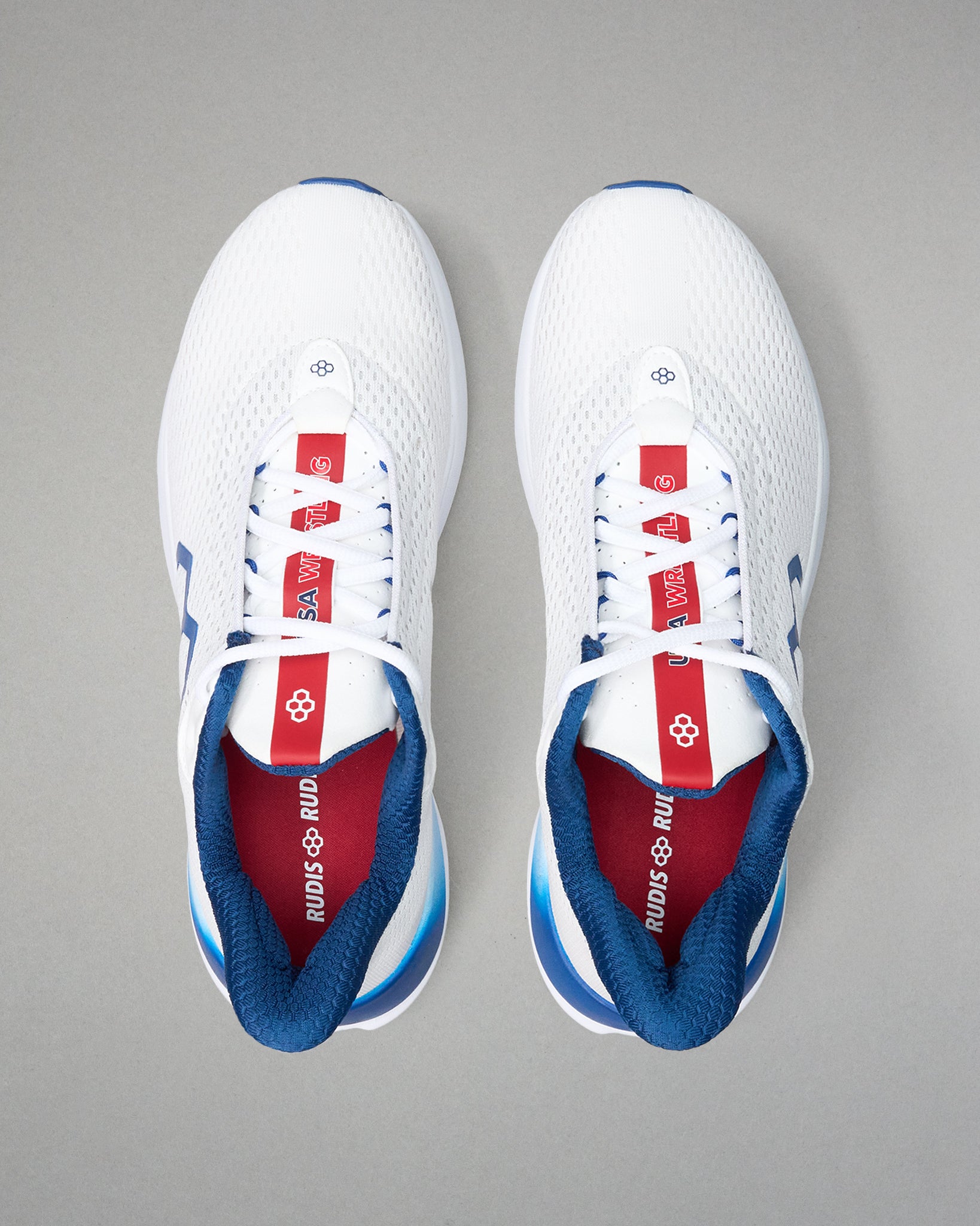 White sneakers with red and blue accents on a gray background