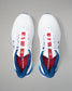 White sneakers with red and blue accents on a gray background