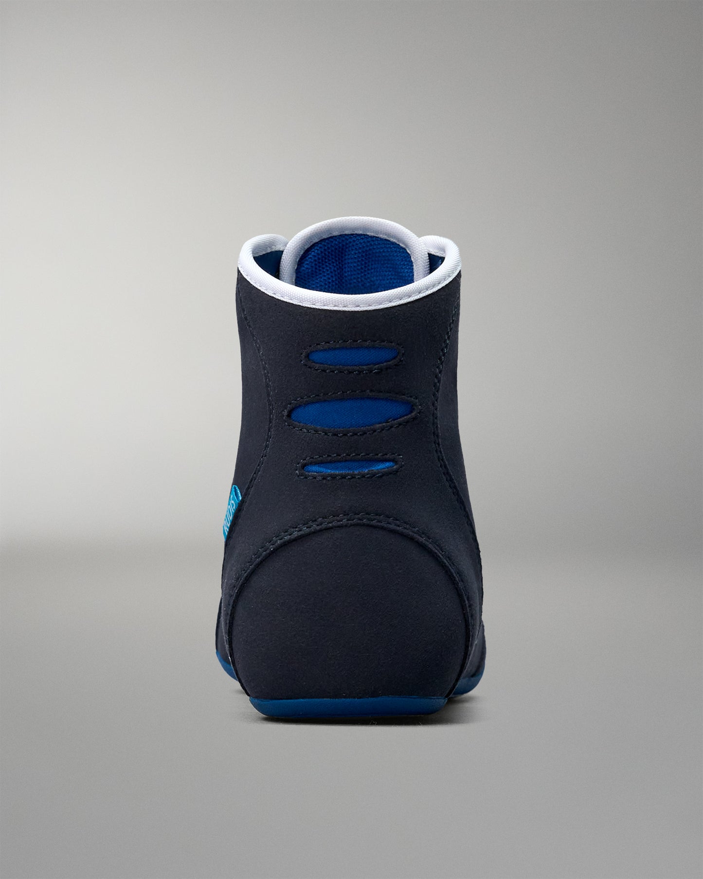 Black and blue wrestling shoe on a gray background