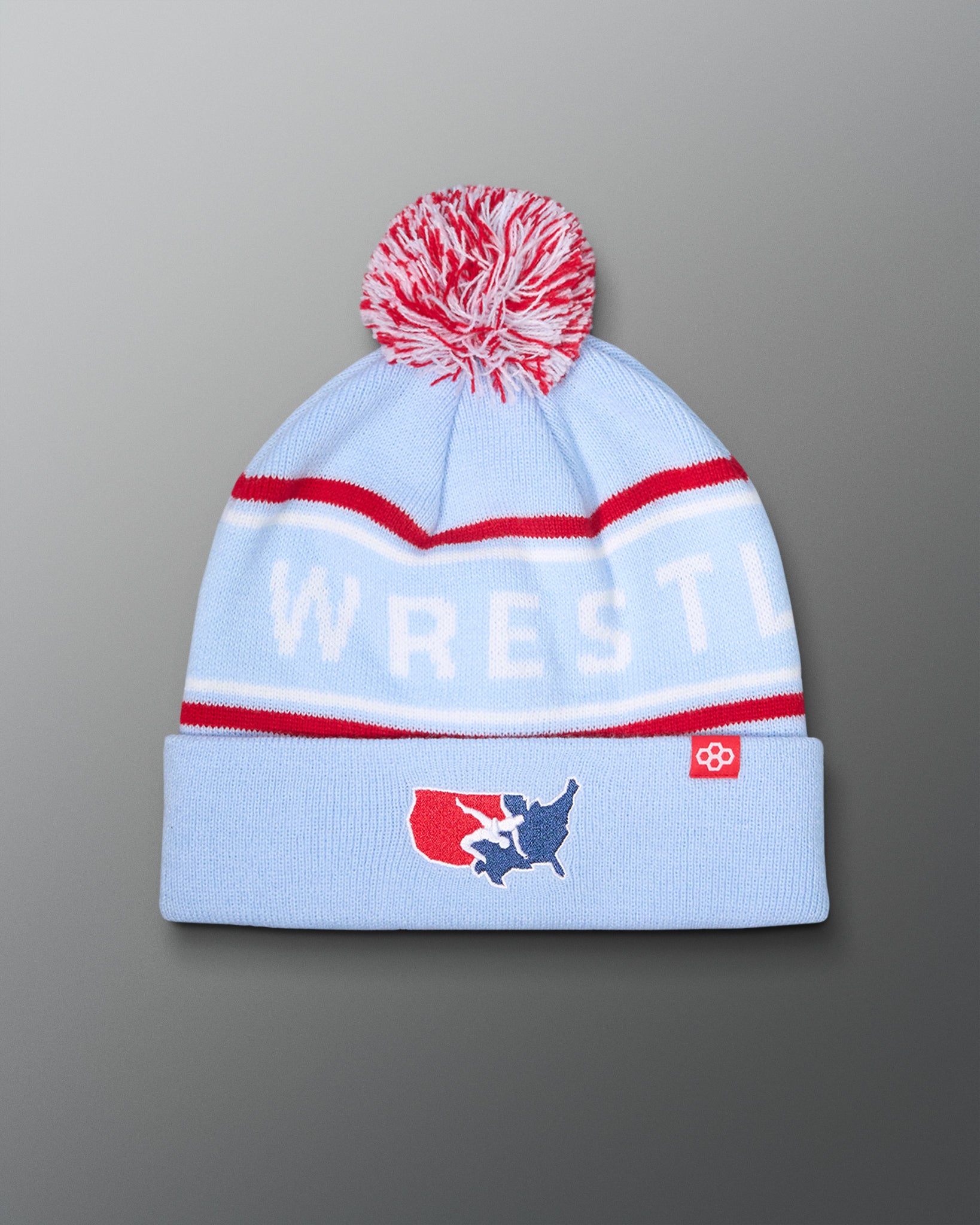 USA Wrestling Logo Light blue knit beanie with red and white accents and 'WRESTLING' text on a gray background
