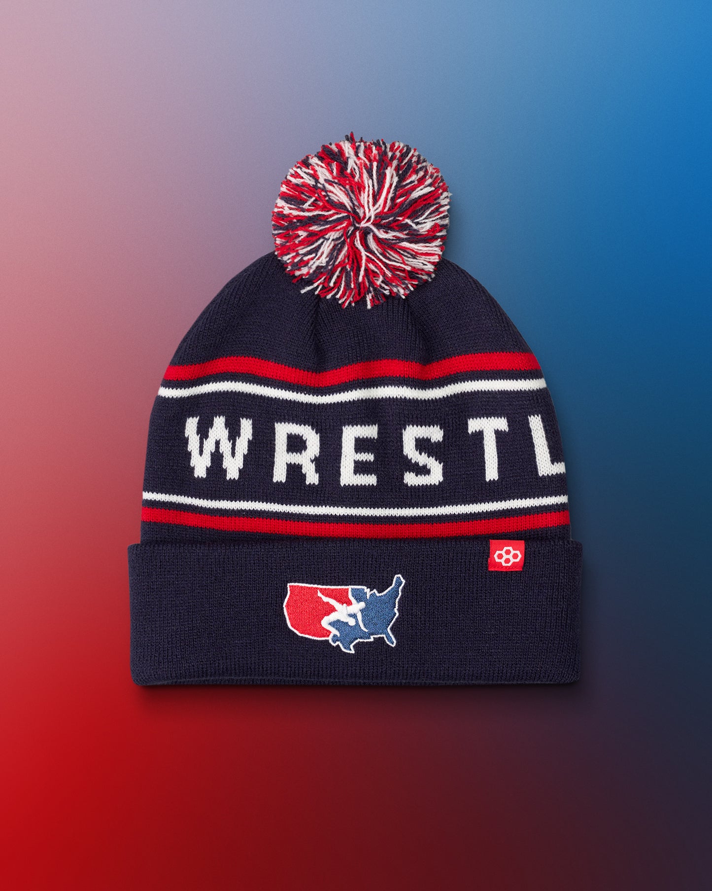 USA Wrestling Logo Navy blue beanie with red and white pom-pom on a gradient background