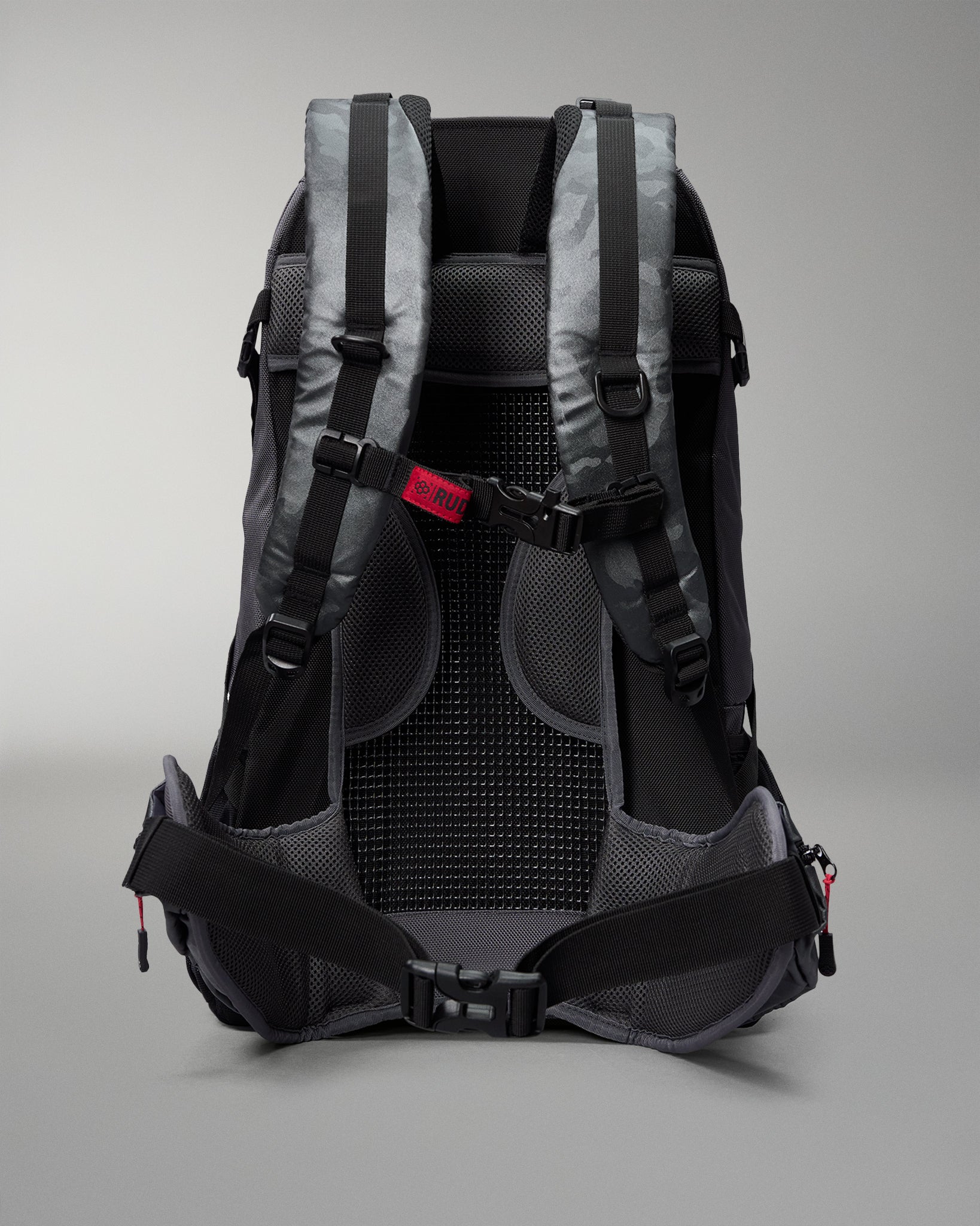 Backpack with gray and black straps on a light gray background