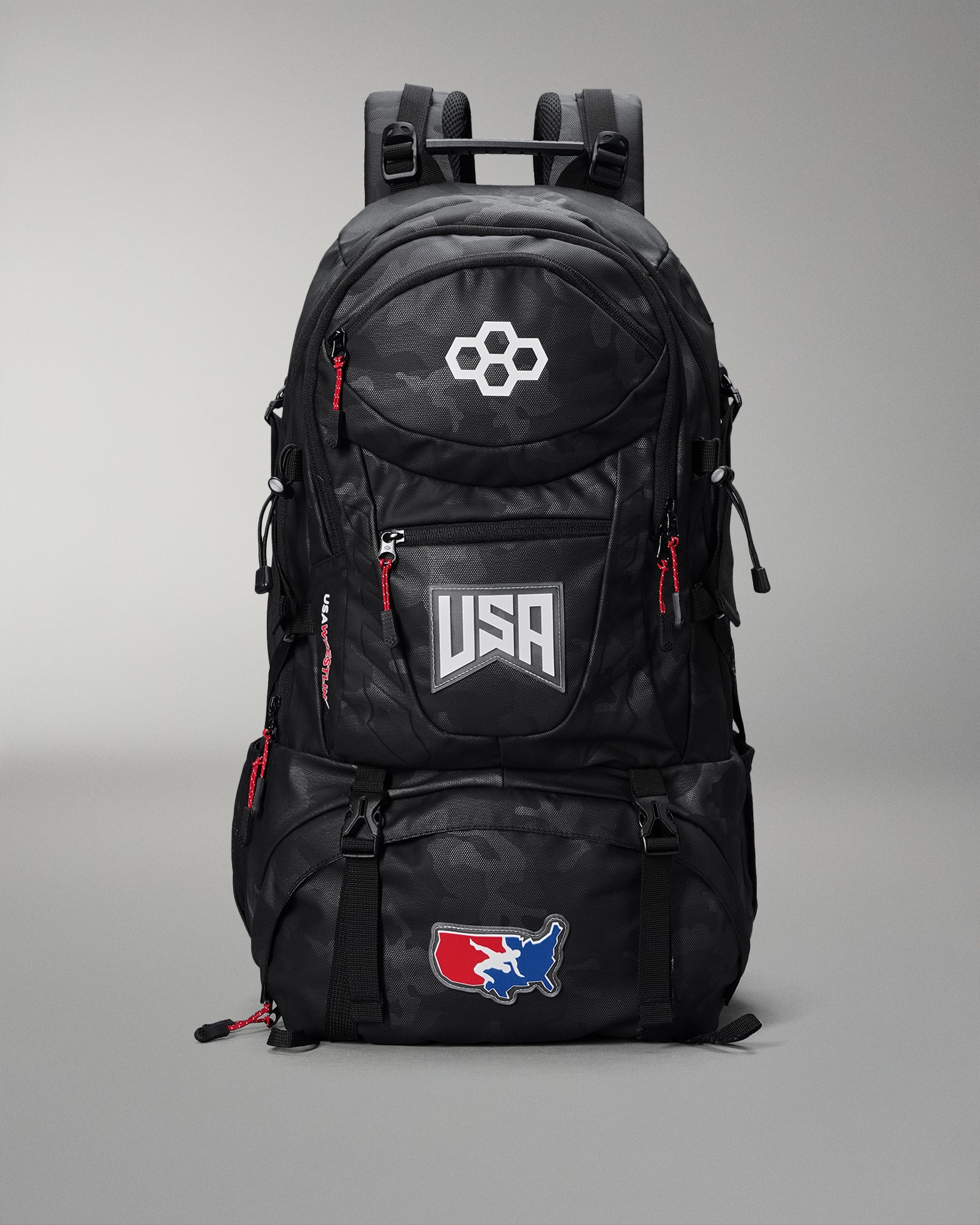 Black backpack with USA and hexagonal logo on a gray background