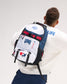 Rear view of a model wearing the RUDIS USA Wrestling Genesis Gearpack III backpack, featuring red, white, and blue panels, USA Wrestling graphics, multiple zippered compartments, and adjustable straps.