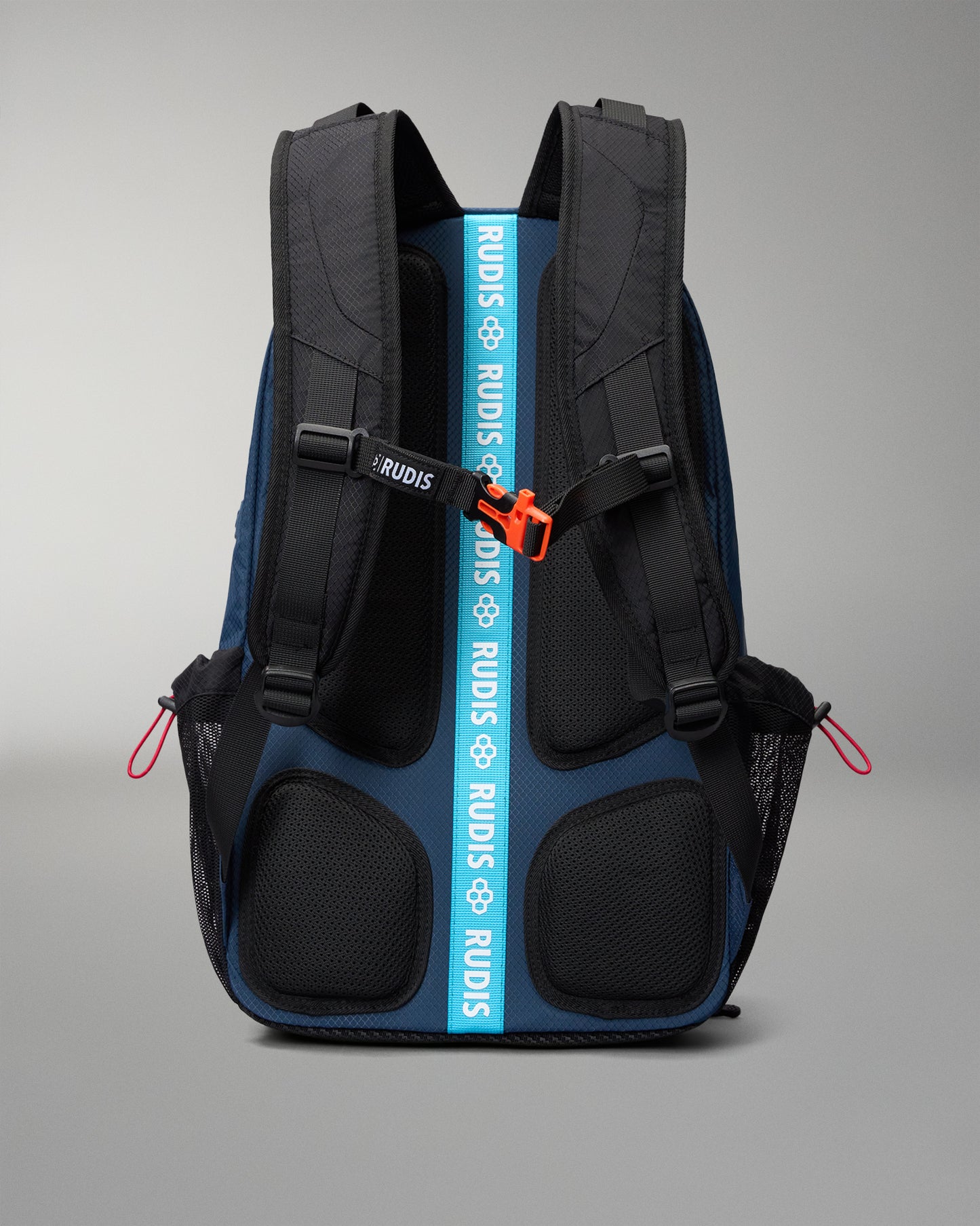 RUDIS backpack shown from the back, featuring a dark blue and black design with a prominent bright blue vertical strap printed with the brand name 'RUDIS' in white, and an orange zipper pull.