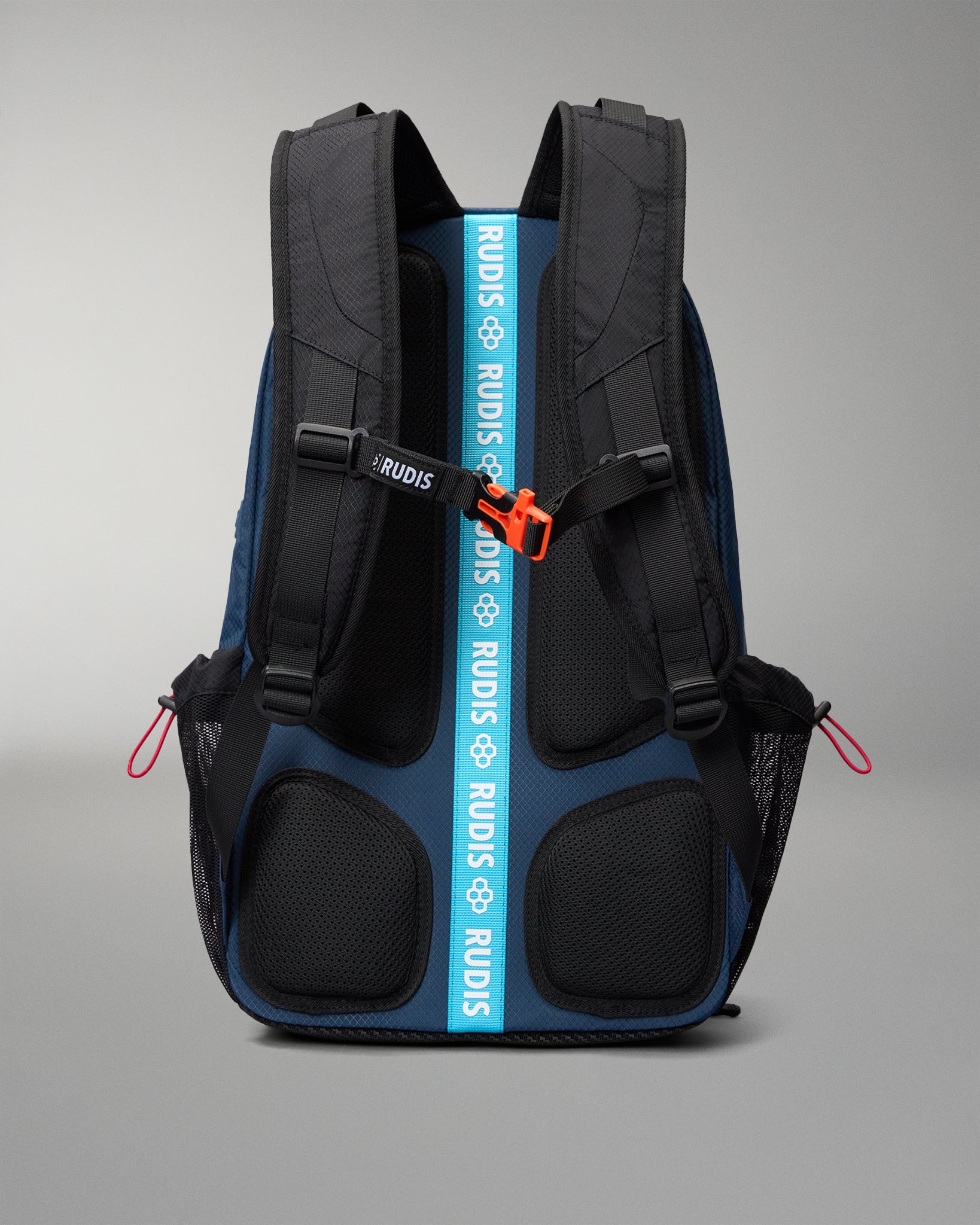 RUDIS backpack shown from the back, featuring a dark blue and black design with a prominent bright blue vertical strap printed with the brand name 'RUDIS' in white, and an orange zipper pull.