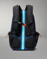 RUDIS backpack shown from the back, featuring a dark blue and black design with a prominent bright blue vertical strap printed with the brand name 'RUDIS' in white, and an orange zipper pull.