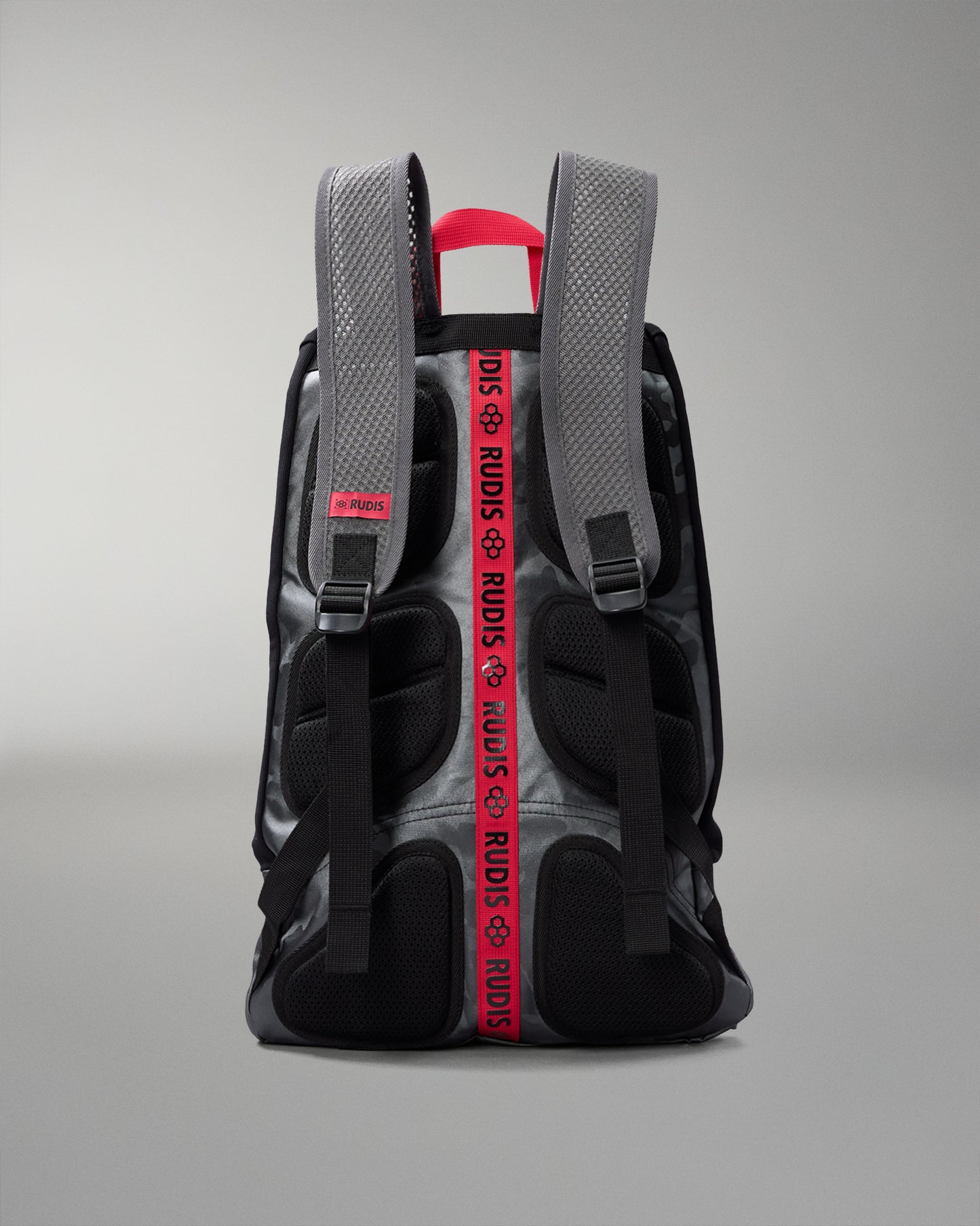 Backpack with visible branding on straps against a gray background