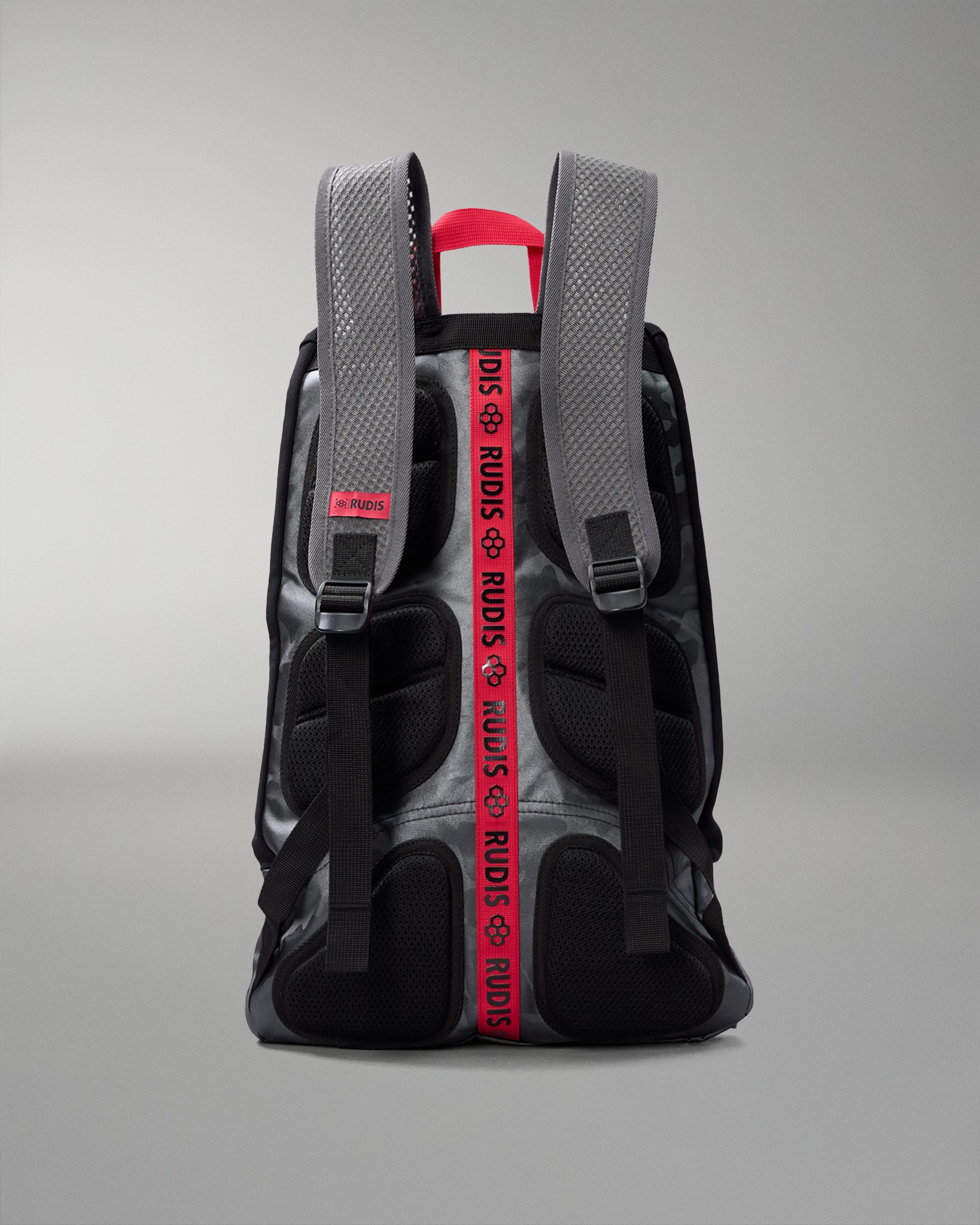 Backpack with visible branding on straps against a gray background