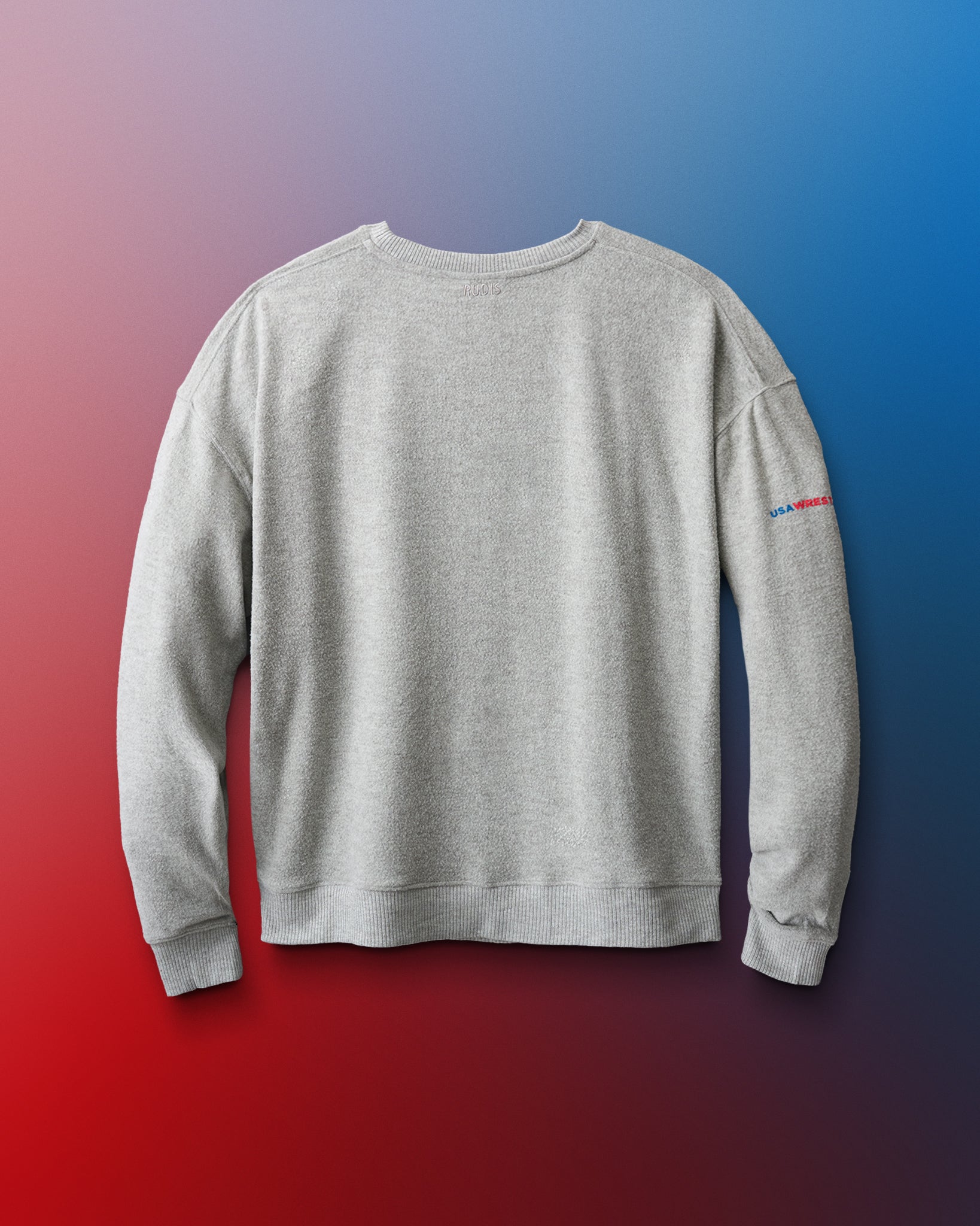 Gray sweatshirt with a small logo on the sleeve against a gradient background