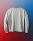 Gray sweatshirt with a small logo on the sleeve against a gradient background