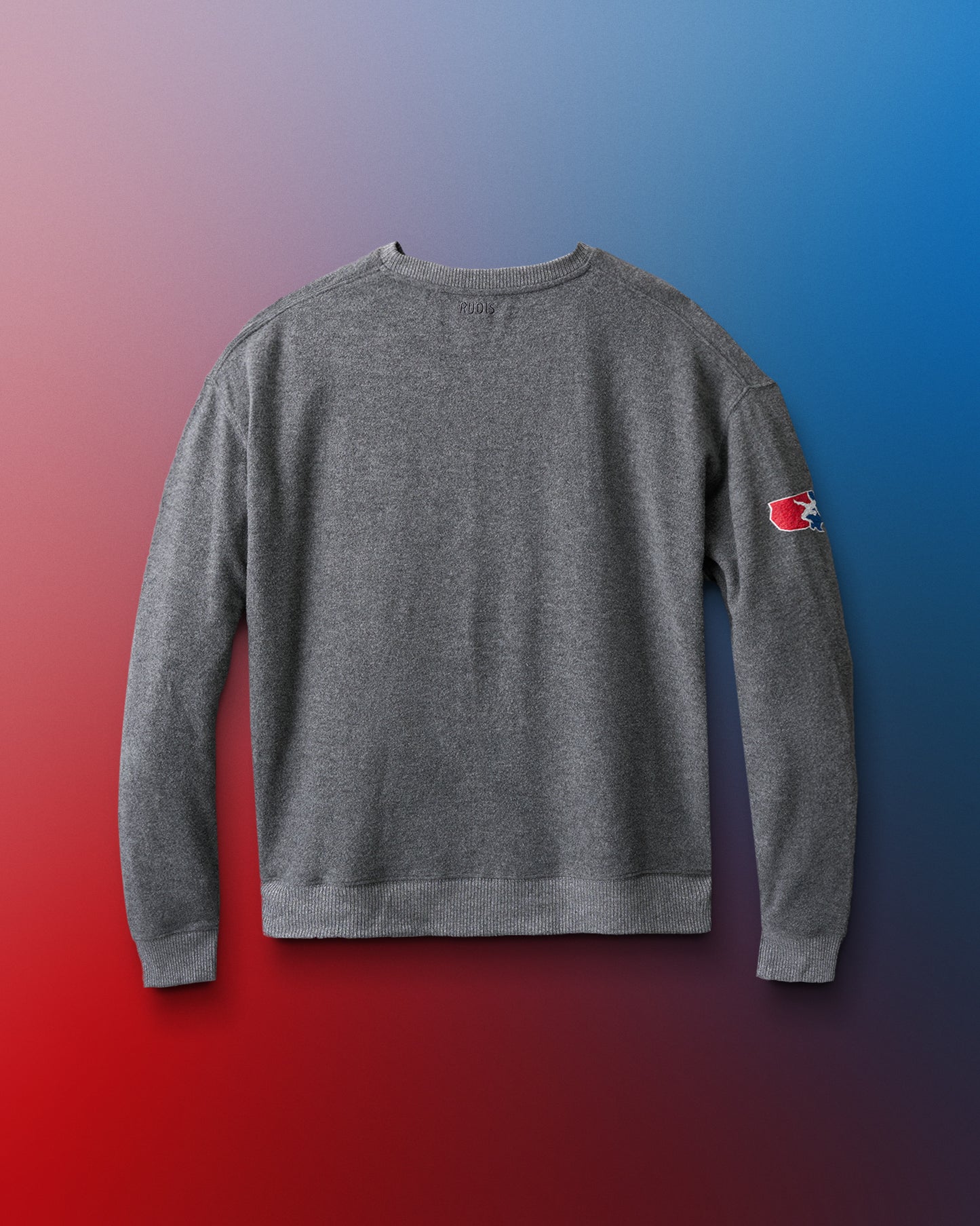 Gray sweatshirt with a logo on the sleeve against a gradient background