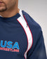 Navy blue sports jacket with 'USA Wrestling' logo on a gray background