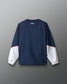 Navy and white long-sleeve shirt with 'RUDIS' branding on a gray background