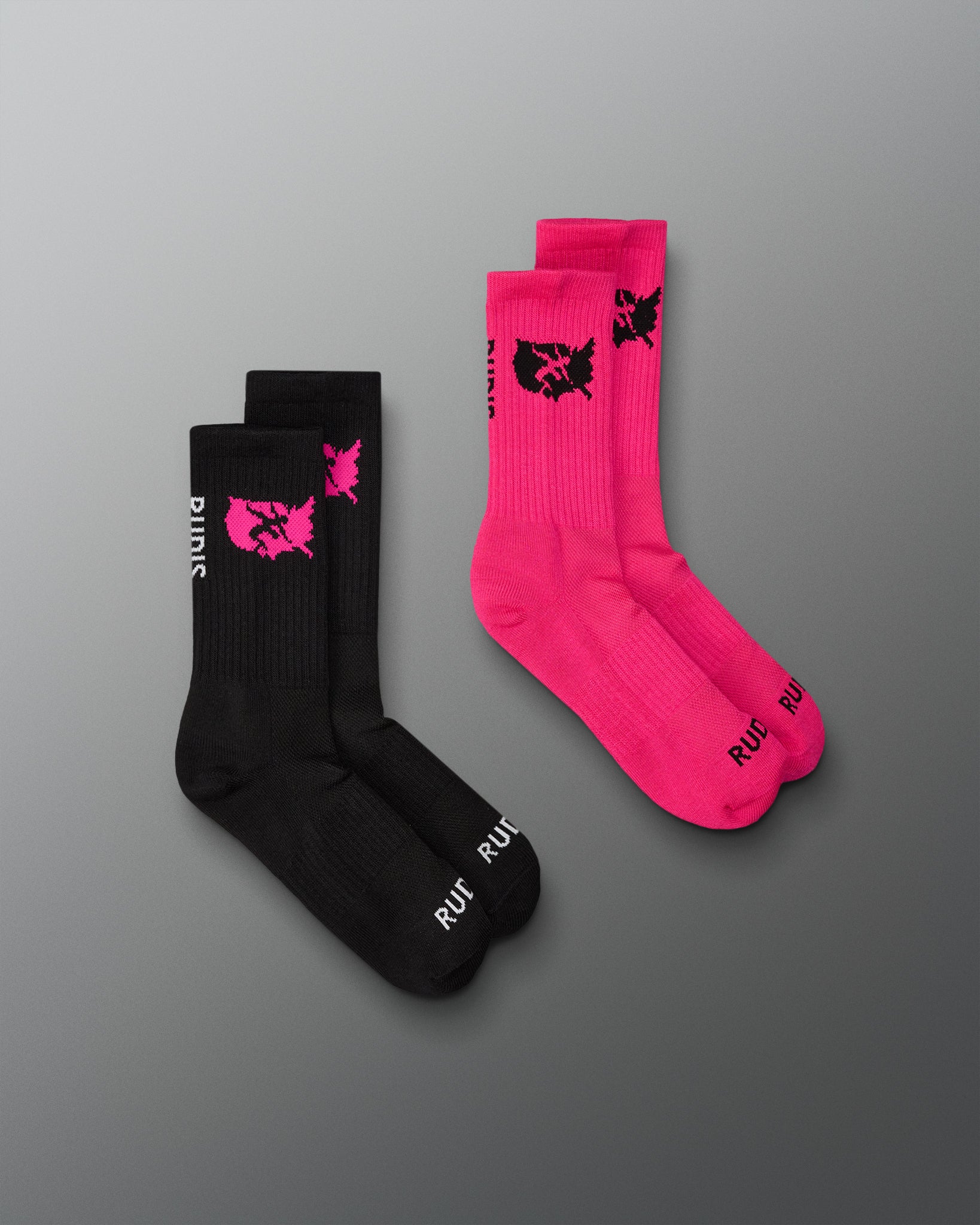 Two pairs of socks, one black and one pink, with a logo on a gray background.
