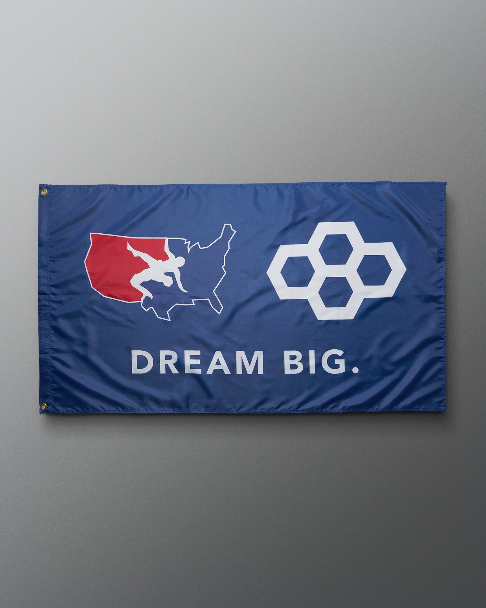 Flag with a map of the United States, a honeycomb design, and 'Dream Big.' text on a gray background