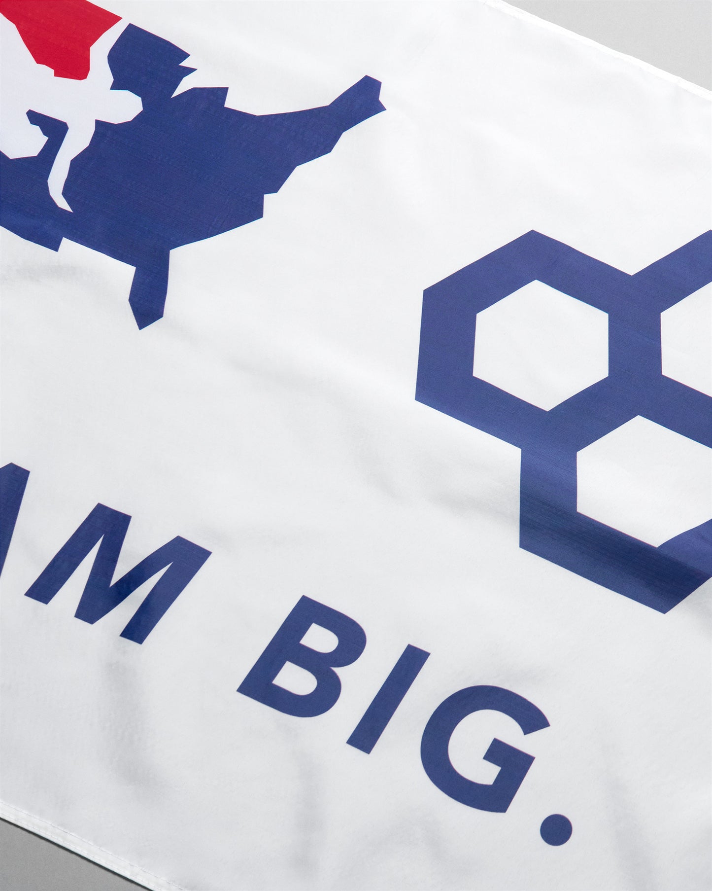 White shirt with blue and red graphics and text on a white background