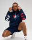 Male model wearing the RUDIS USA Wrestling Map Relaxed Comfort Fleece Hoodie in Navy, showing the red, white and blue map graphic, USA sleeve lettering and kangaroo pocket.