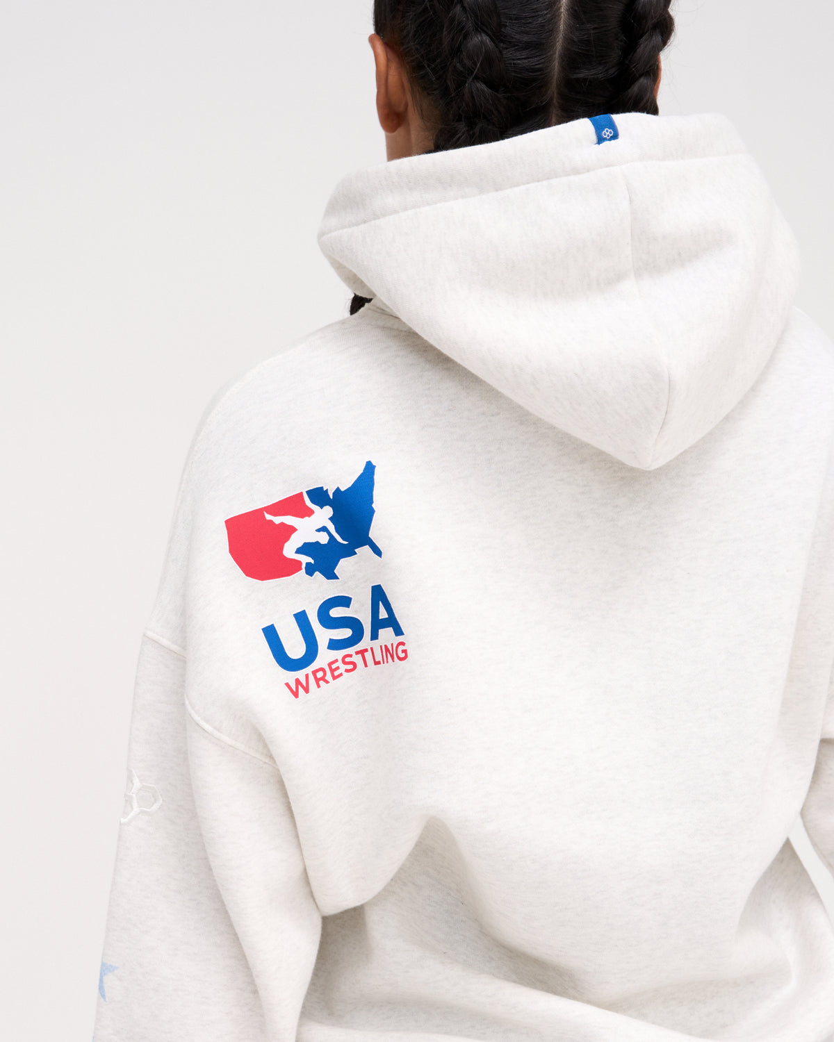 Back view of the RUDIS USA Wrestling Star Relaxed Comfort Fleece Hoodie in Heather Silver, highlighting the red, white and blue USA Wrestling map logo below the hood.