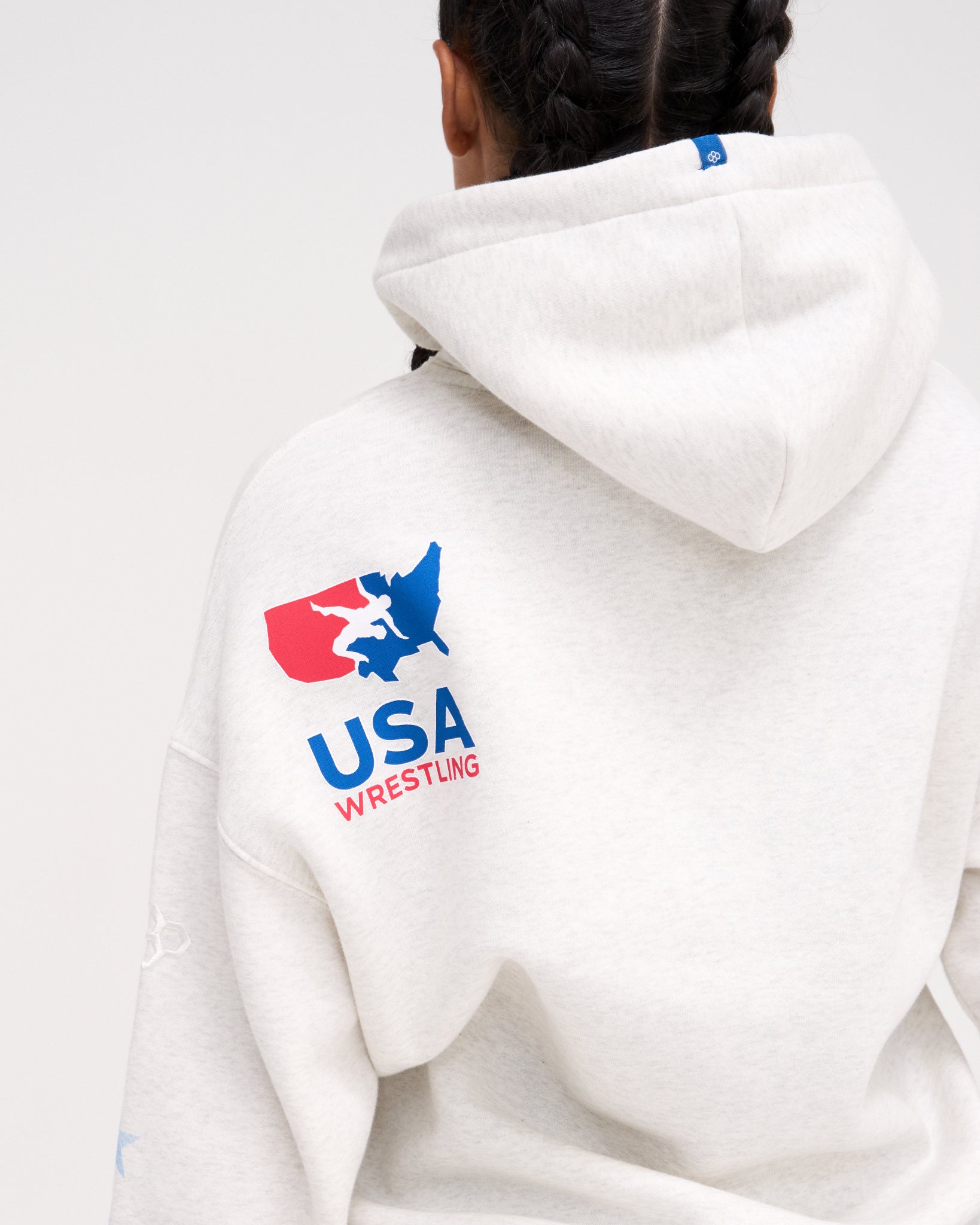 Back view of the RUDIS USA Wrestling Star Relaxed Comfort Fleece Hoodie in Heather Silver, highlighting the red, white and blue USA Wrestling map logo below the hood.
