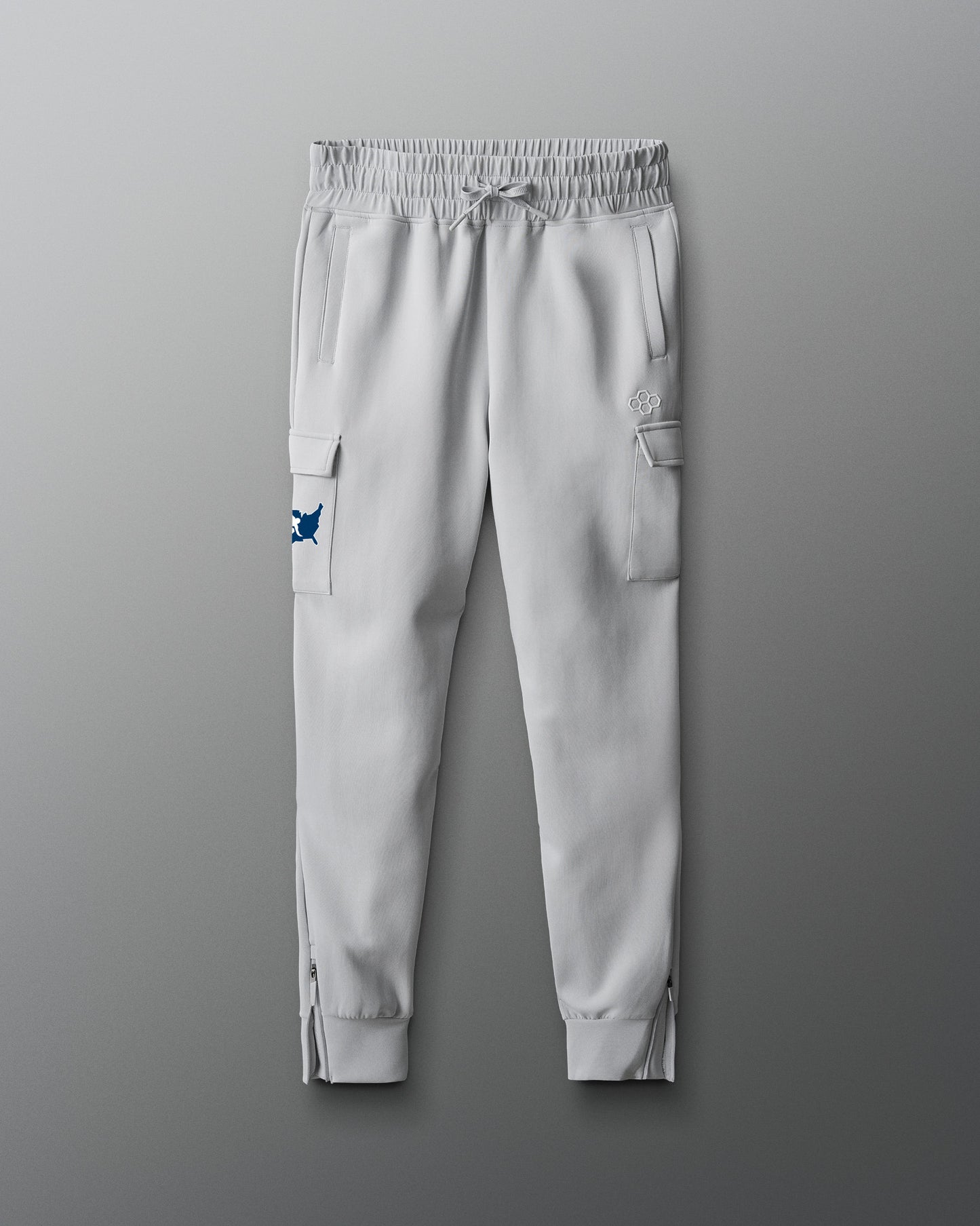 Light gray jogger pants with cargo pockets on a gray background