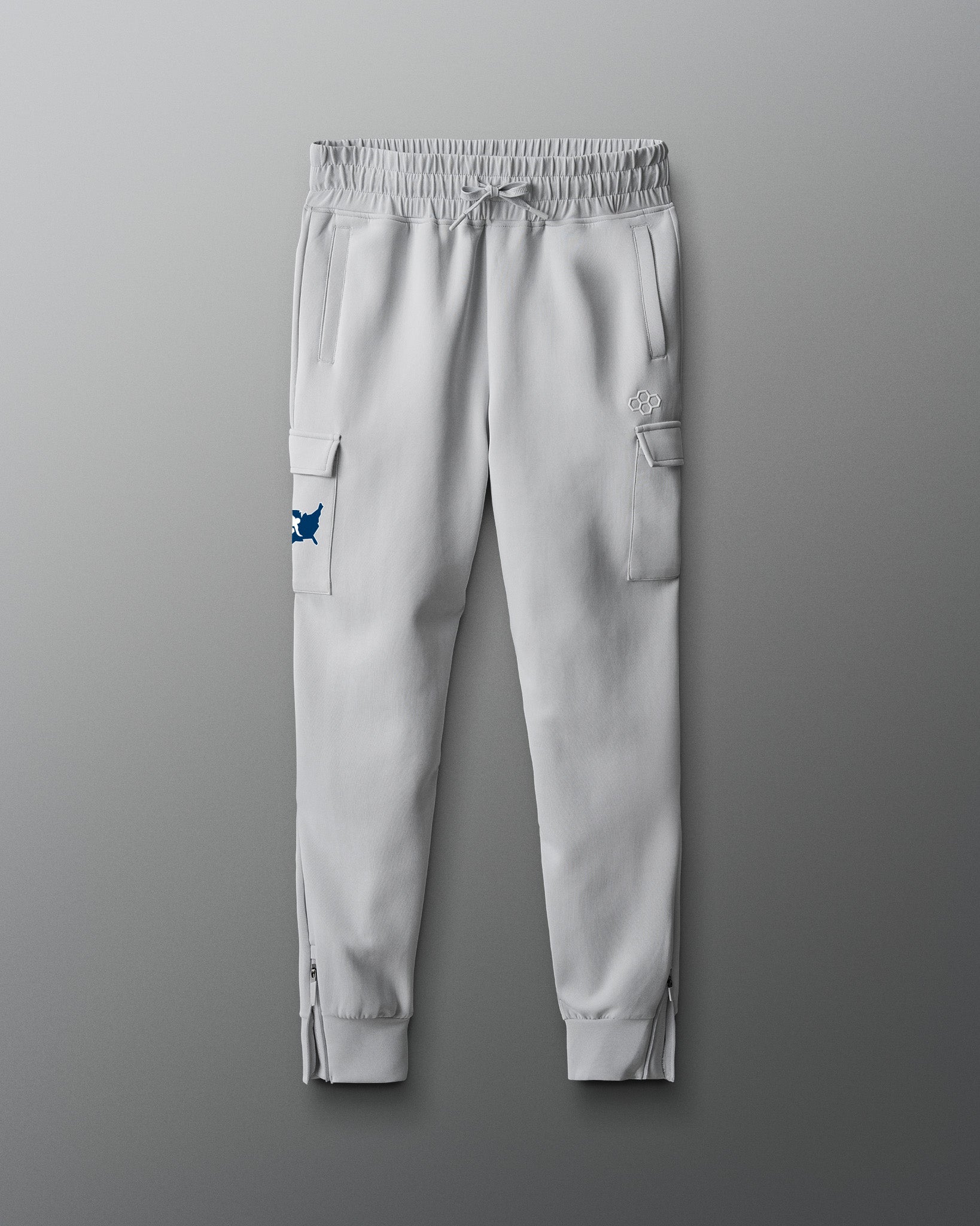 Light gray jogger pants with cargo pockets on a gray background