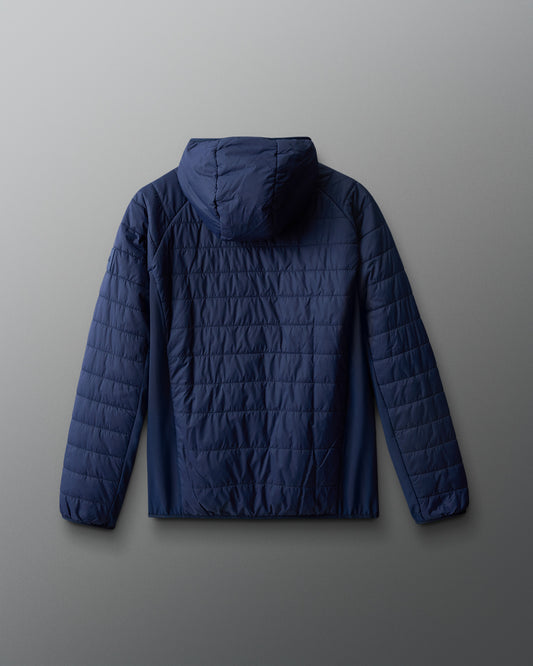 Dark blue quilted jacket on a gradient red to blue background