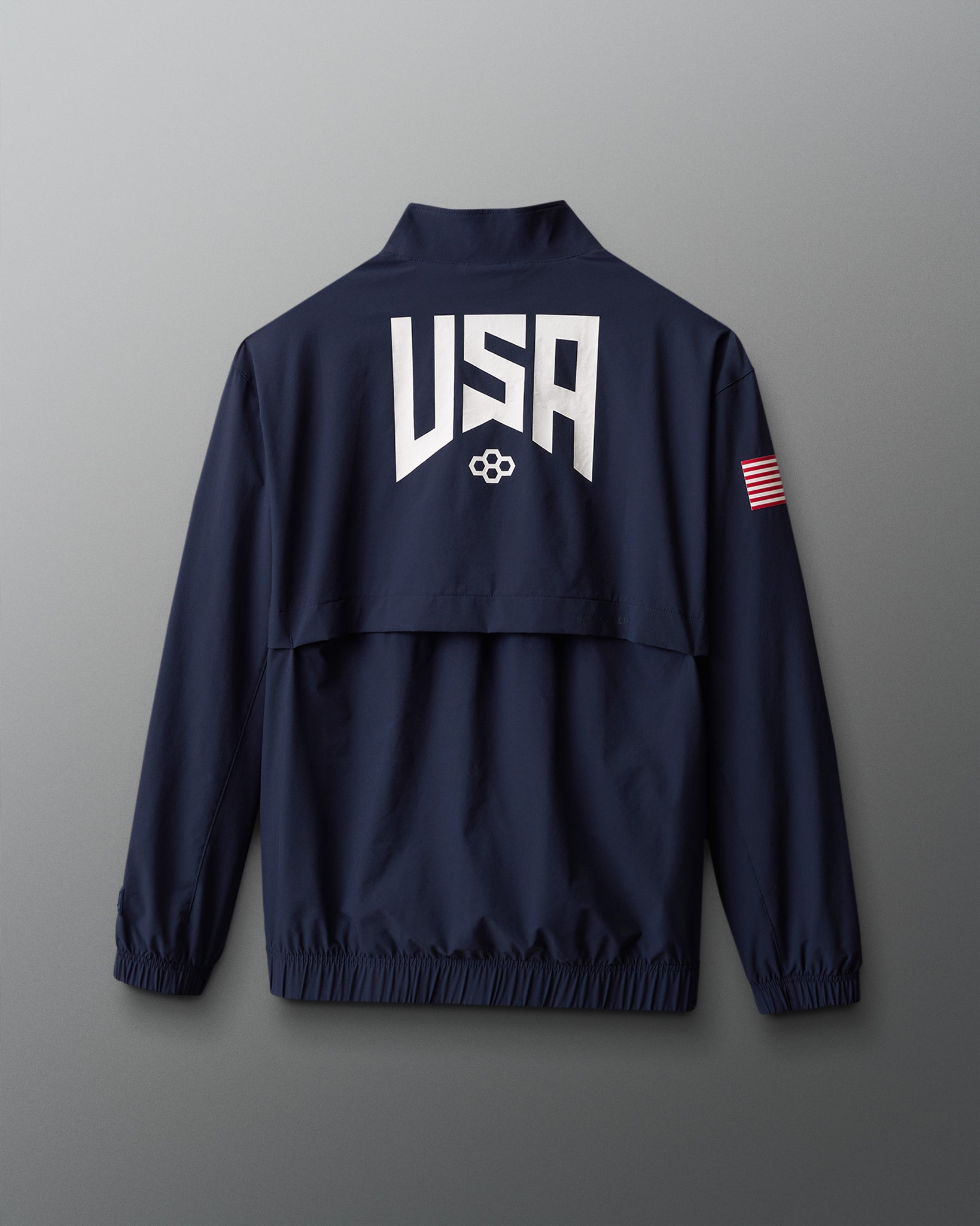 Navy blue jacket with 'USA' logo on the back against a gray background