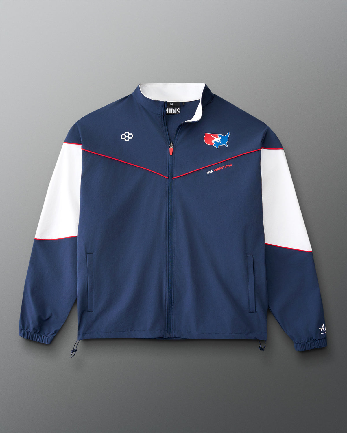 Front view of the RUDIS USA Wrestling Full Zip Movement Podium Jacket in navy, featuring white sleeve panels, red piping, USA Wrestling graphics, and full-zip styling.