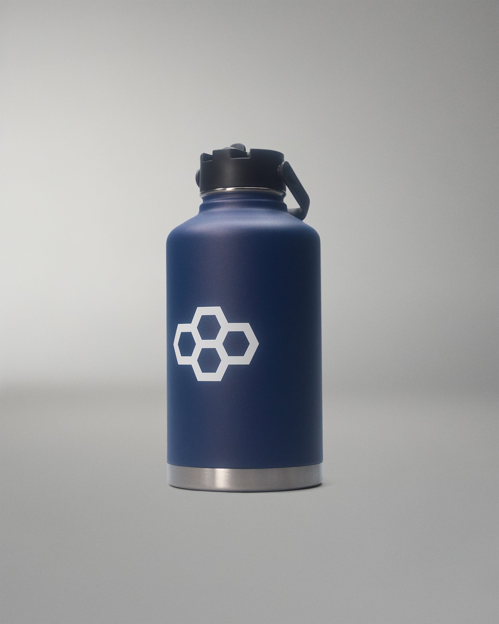 Navy blue water bottle with a white logo on a gray background