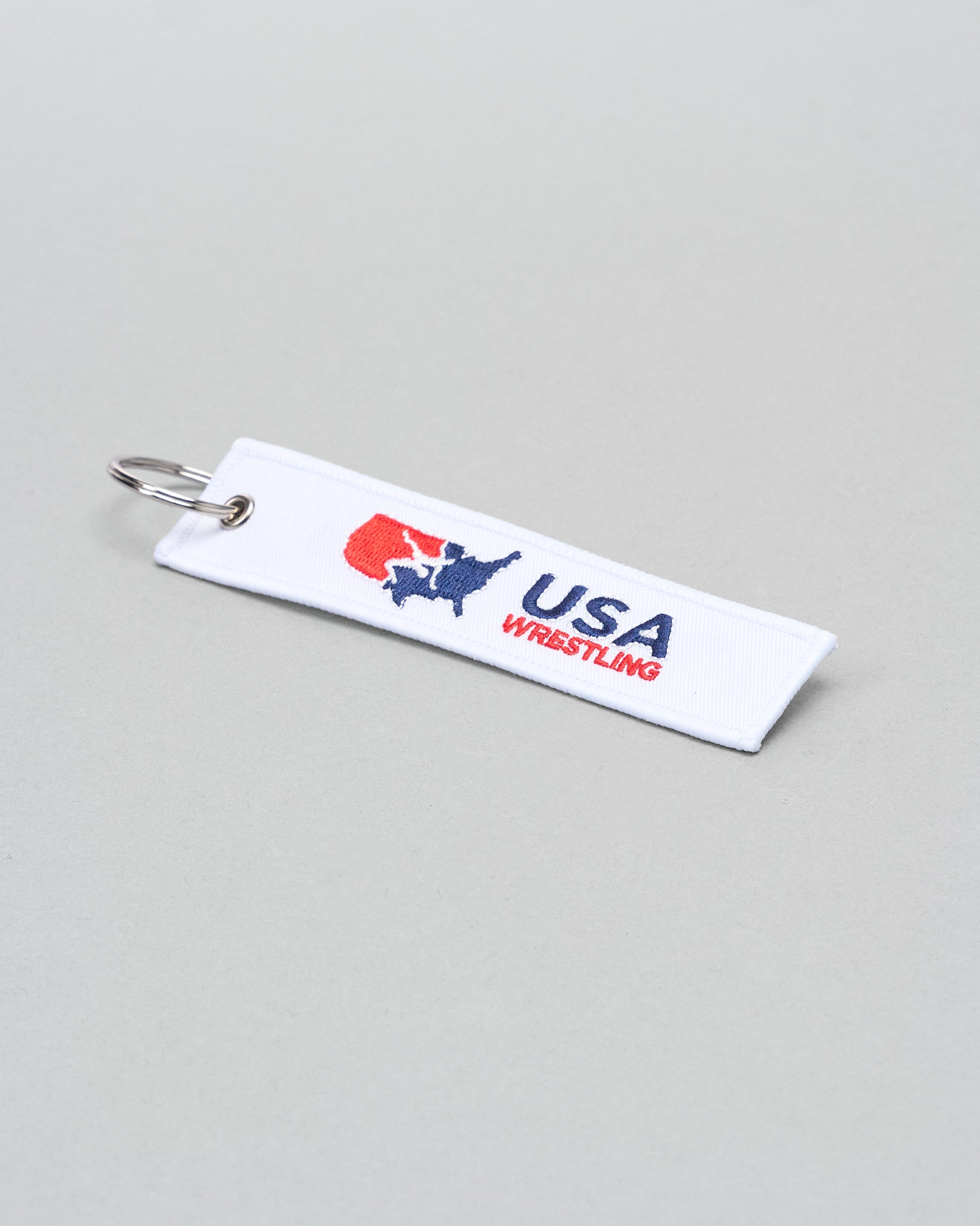 USA Wrestling keychain on a gray background