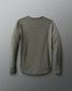 Green long-sleeve shirt on a gray background
